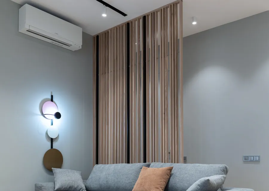 A living room with a wall-mounted split air-conditioning unit